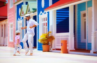 happy father and son enjoy life, dancing on caribbean street