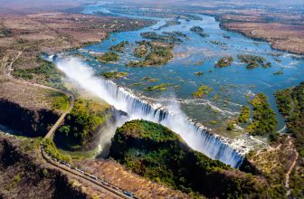 The Victoria falls is the largest curtain of water in the world (1708 m wide). The falls and the surrounding area is the National Parks and World Heritage Site (helicopter view) - Zambia, Zimbabwe
